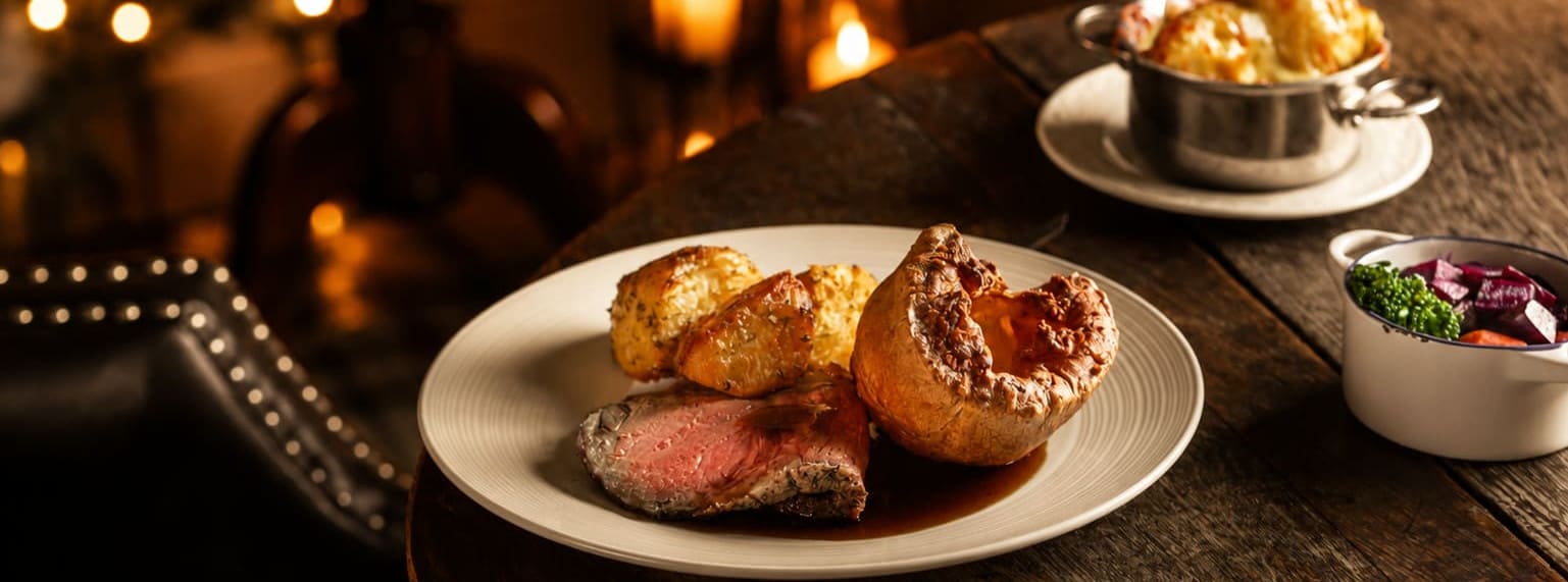 Festive roast dinner at Washingborough Hall with Yorkshire pudding, roast potatoes, seasonal vegetables and warm Christmas candlelight.