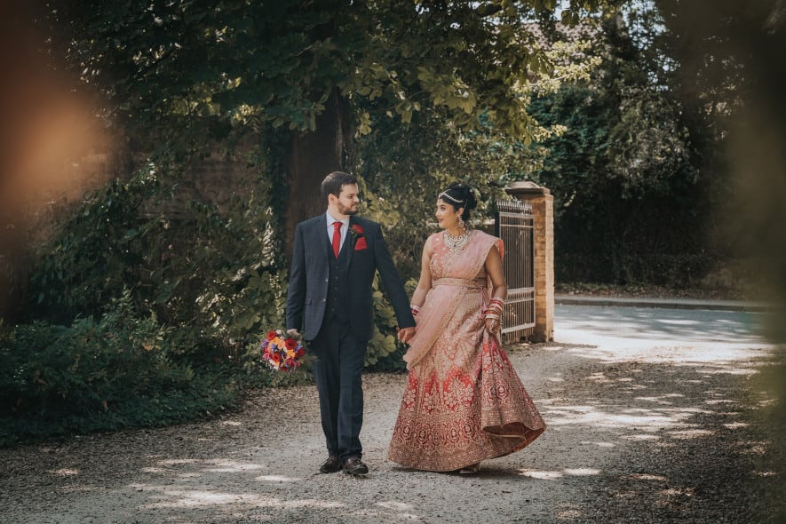 Bride and Groom walking up driveway