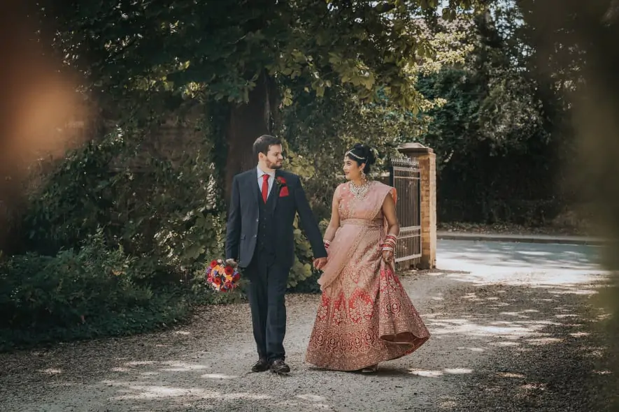 Bride and Groom walking up driveway