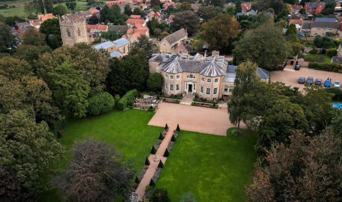 a drone image has been taken overhead of Washingborough Hall, with the grounds in the front, and the church and village behind the hotel